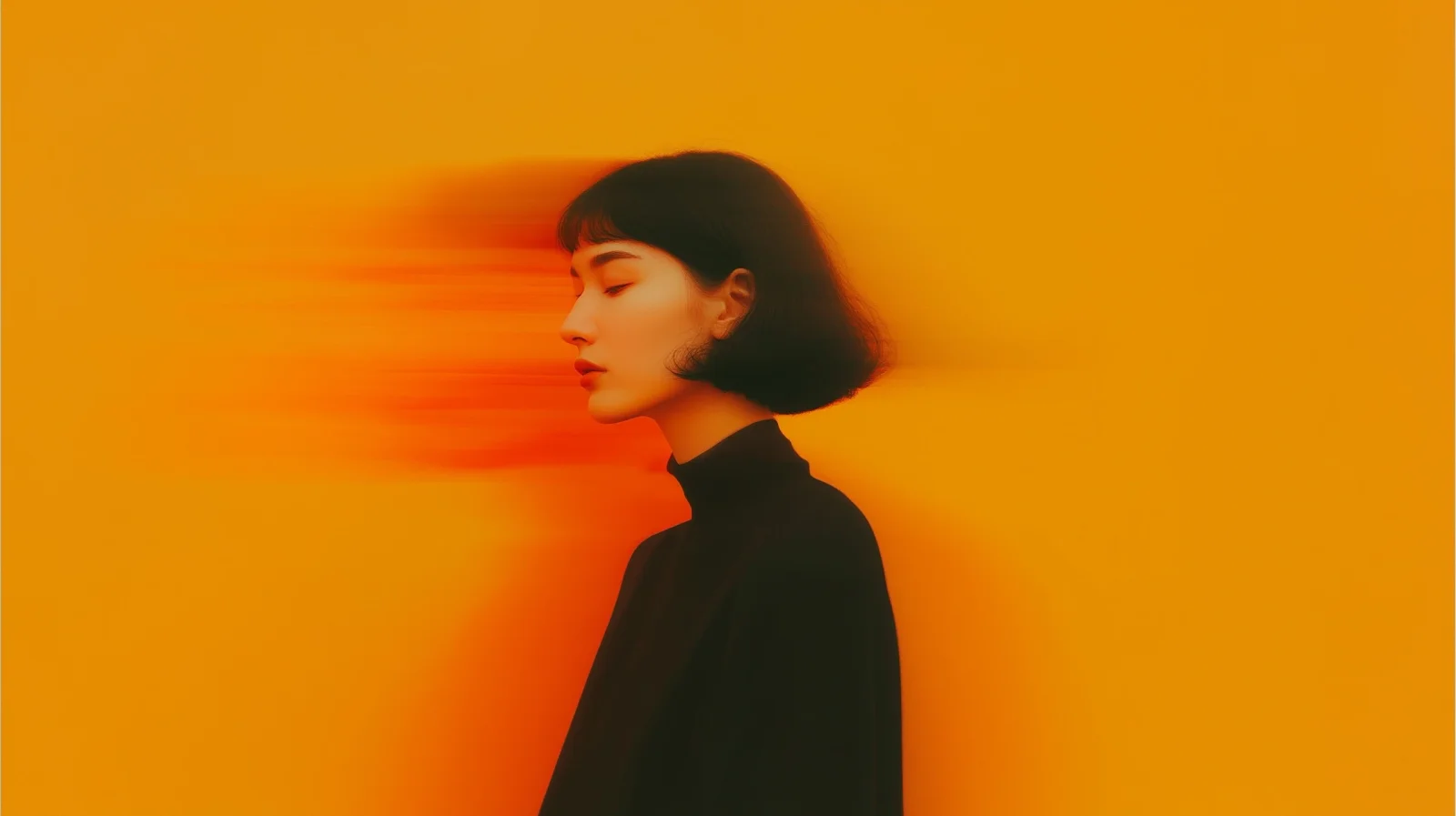 An expressive portrait against warm orange