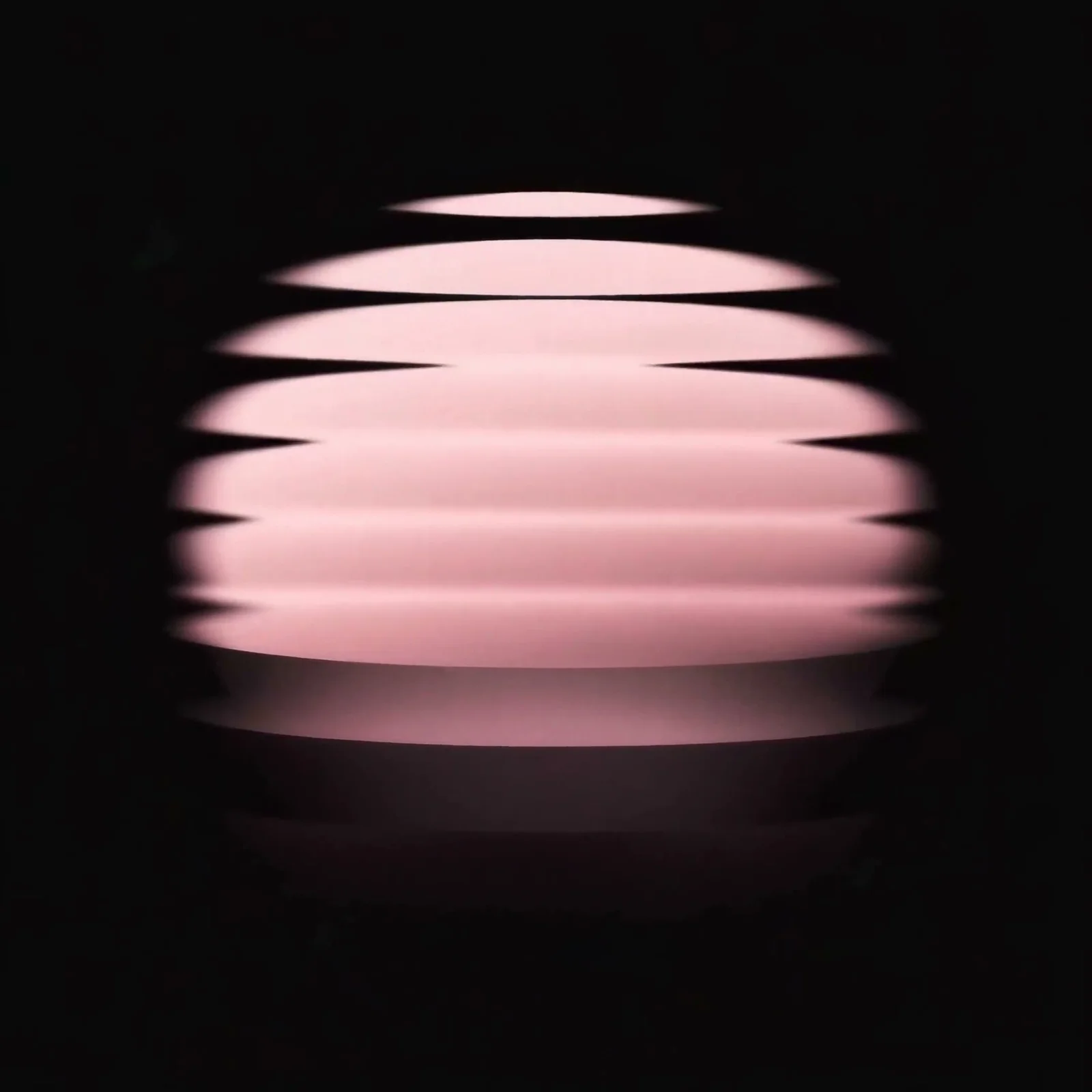 A glowing pink form made of floating layers