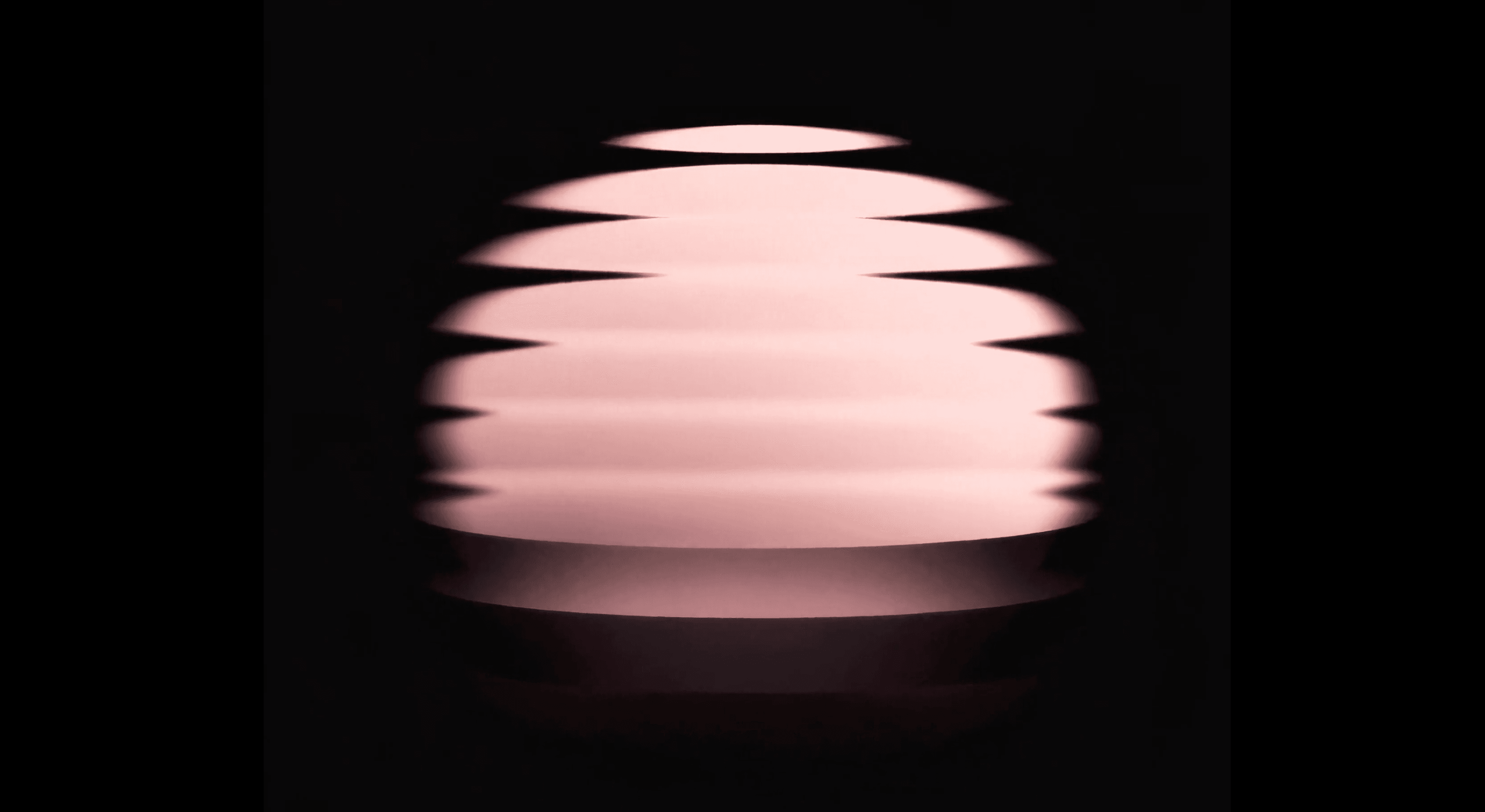 A glowing rose-pink sphere split into floating horizontal layers against a black background